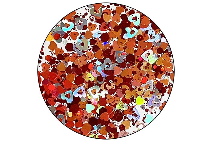A pot of multicolored nail glitter appearing as various sizes and shapes, predominantly hearts and rounds, with a mix of pink, red, silver, and gold hues.